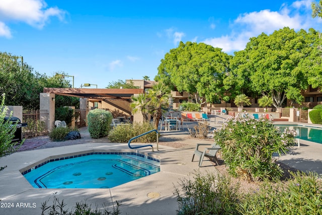 view of pool with a patio and a community hot tub