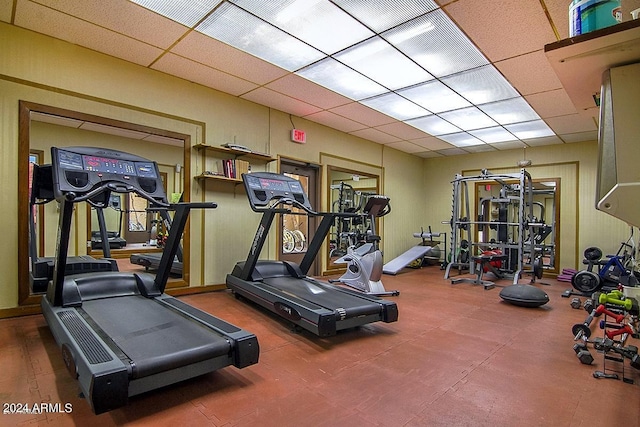 gym with a paneled ceiling