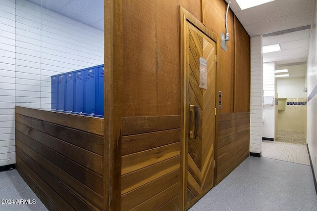 interior space featuring wooden walls