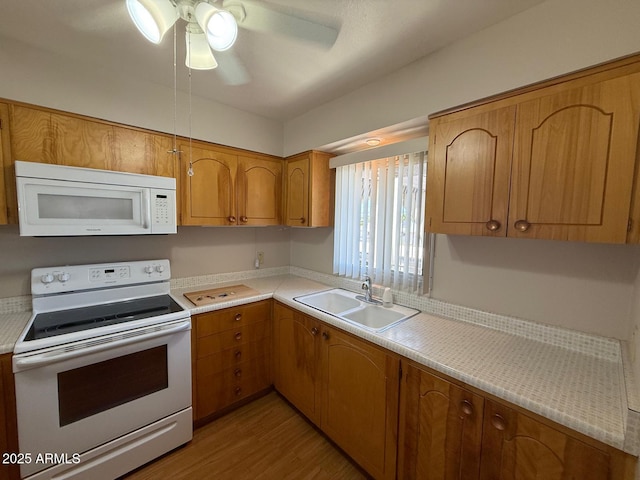131 N Higley Rd Unit 215, Mesa, AZ 85205 - kitchen with white appliances, light countertops, light wood finished floors, and a ceiling fan