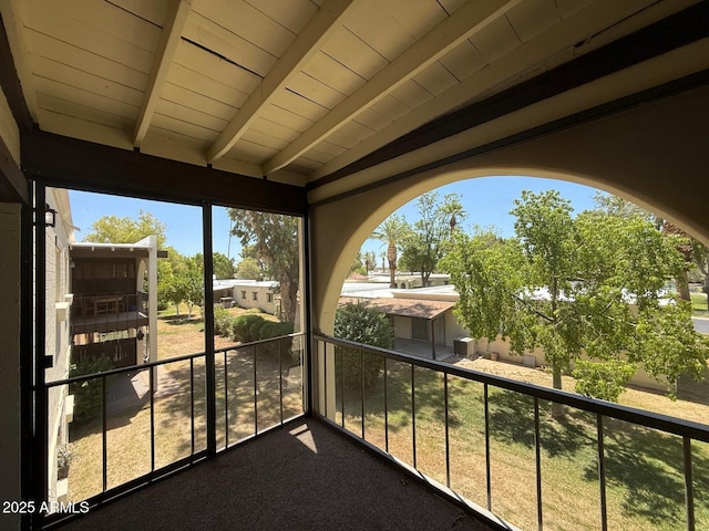 131 N Higley Rd Unit 215, Mesa, AZ 85205 - unfurnished sunroom featuring beam ceiling