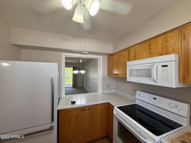 131 N Higley Rd Unit 215, Mesa, AZ 85205 - kitchen featuring white appliances, light countertops, brown cabinetry, and ceiling fan