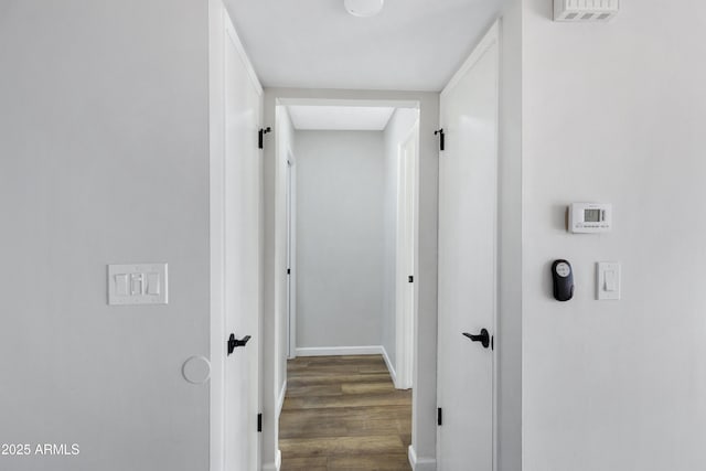 hall with dark hardwood / wood-style flooring