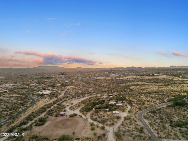 aerial view at dusk featuring a mountain view