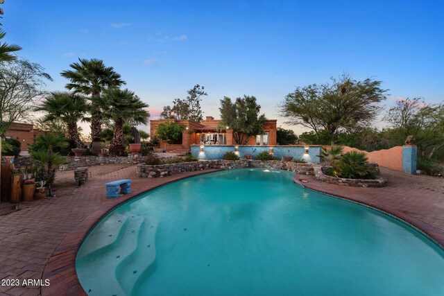 view of pool at dusk