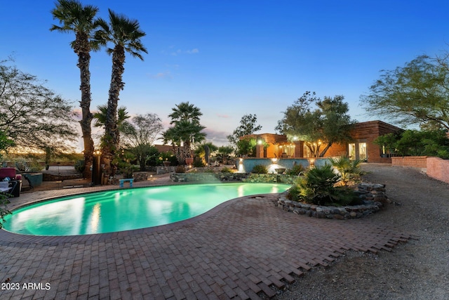 pool at dusk with a patio