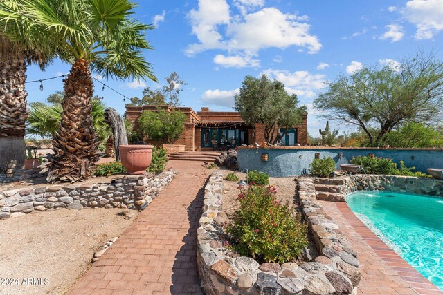 view of pool with pool water feature