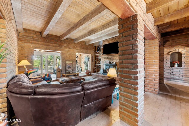 living room with brick wall, beam ceiling, and wooden ceiling