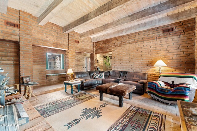 living room with wood ceiling, brick wall, wood-type flooring, and beam ceiling