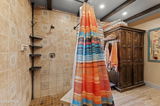 bathroom featuring a shower with curtain, beam ceiling, and hardwood / wood-style flooring