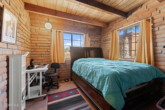 bedroom featuring brick wall, beam ceiling, and wooden ceiling