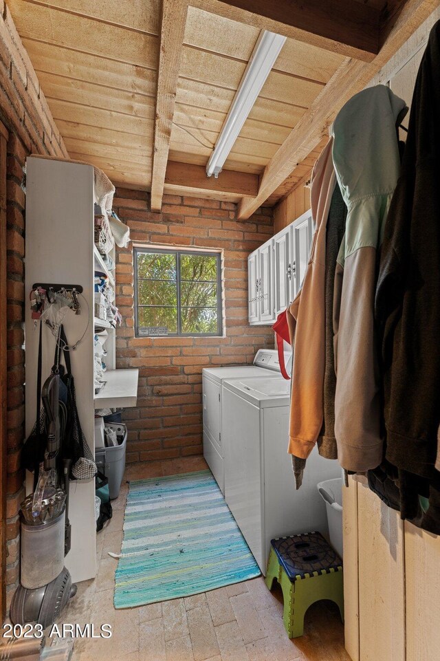 laundry room featuring washing machine and clothes dryer and wood ceiling