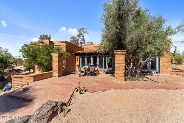 rear view of house featuring a patio