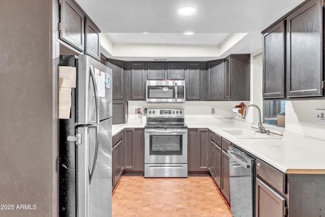 kitchen with dark brown cabinetry, sink, and stainless steel appliances