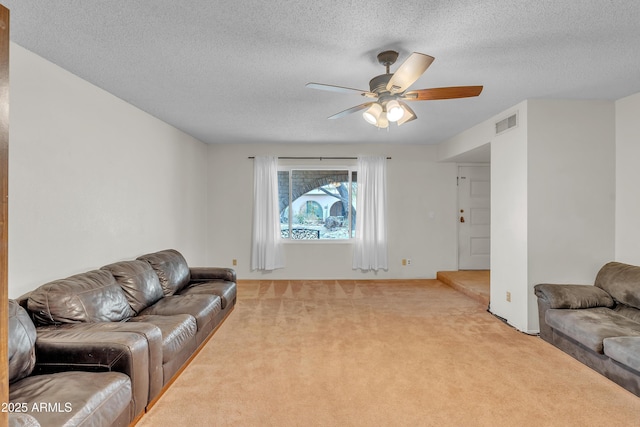 living room with light colored carpet, a textured ceiling, and ceiling fan