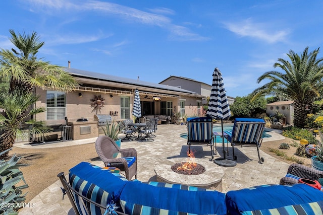 10359 E Los Lagos Vista Ave, Mesa, AZ 85209 - view of patio / terrace featuring an outdoor living space with a fire pit, an outdoor kitchen, outdoor dining area, and a grill