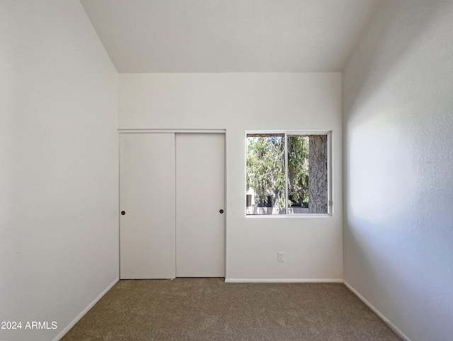 unfurnished bedroom featuring a closet and carpet floors