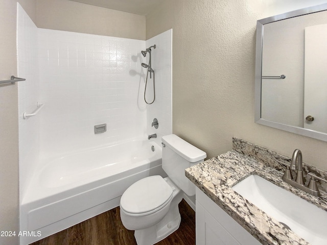 full bathroom featuring shower / washtub combination, hardwood / wood-style floors, vanity, and toilet