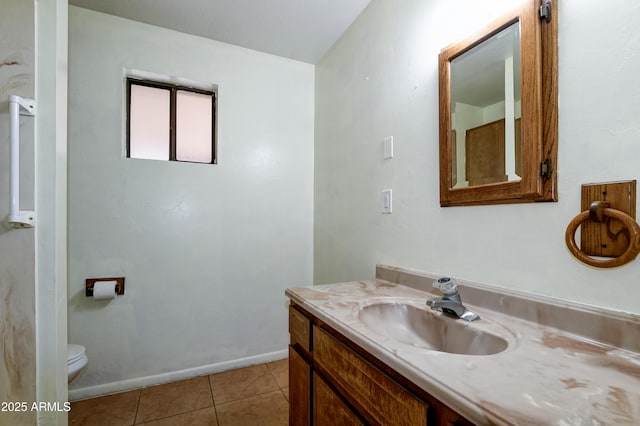 bathroom with tile patterned floors, vanity, and toilet