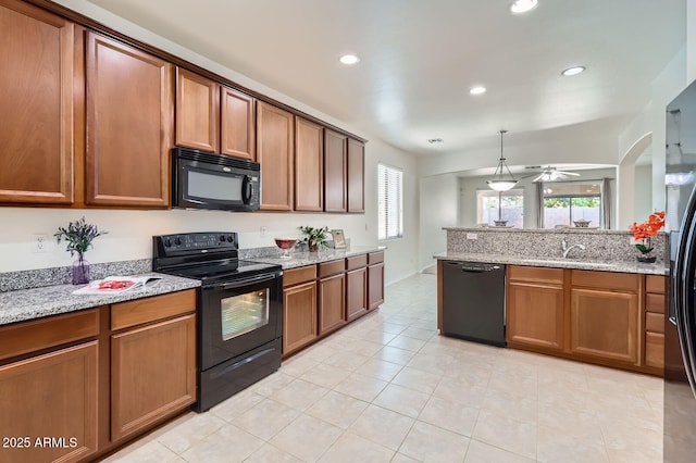 6815 W Carter Rd, Laveen, AZ 85339 - kitchen featuring black appliances, a sink, brown cabinetry, recessed lighting, and light tile patterned flooring