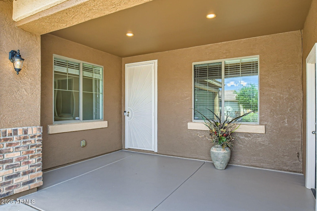 doorway to property with stucco siding and a patio