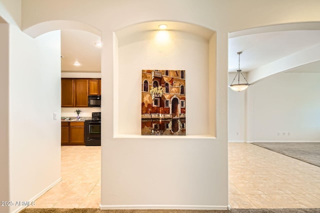 6815 W Carter Rd, Laveen, AZ 85339 - hall with arched walkways, light tile patterned flooring, and recessed lighting