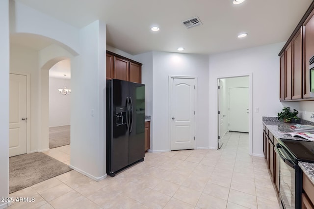 6815 W Carter Rd, Laveen, AZ 85339 - kitchen featuring black appliances, stone counters, arched walkways, recessed lighting, and light tile patterned flooring