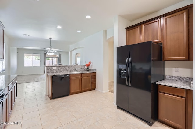 6815 W Carter Rd, Laveen, AZ 85339 - kitchen with black appliances, arched walkways, a peninsula, a ceiling fan, and a sink