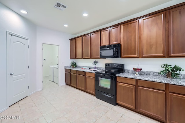 6815 W Carter Rd, Laveen, AZ 85339 - kitchen with black appliances, independent washer and dryer, light stone counters, recessed lighting, and light tile patterned flooring