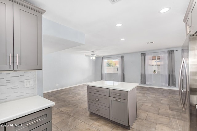 kitchen with gray cabinets, stainless steel fridge, and ceiling fan