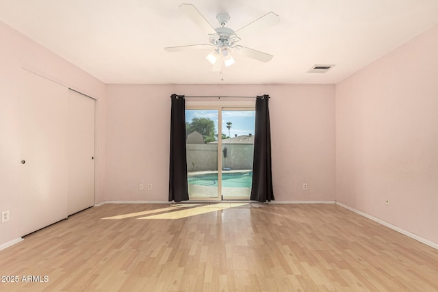 unfurnished room with ceiling fan and light hardwood / wood-style flooring