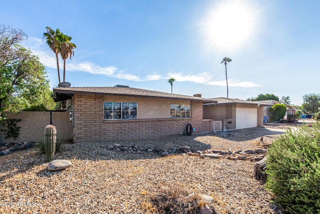 view of front of house with a garage and central AC unit