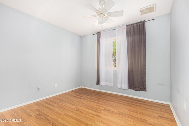 spare room featuring ceiling fan and light wood-type flooring