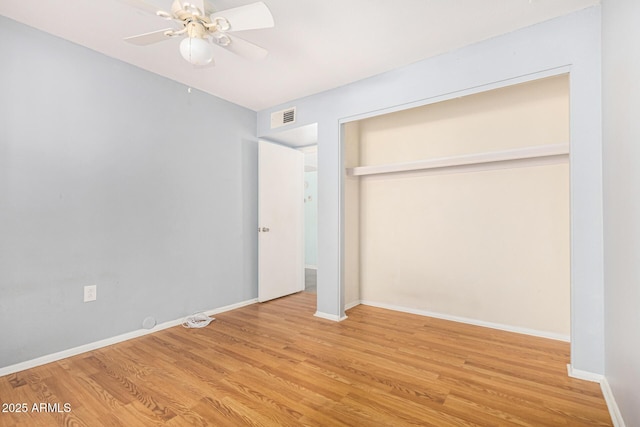 unfurnished bedroom with light hardwood / wood-style floors, a closet, and ceiling fan