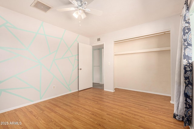 unfurnished bedroom featuring wood-type flooring, a closet, and ceiling fan