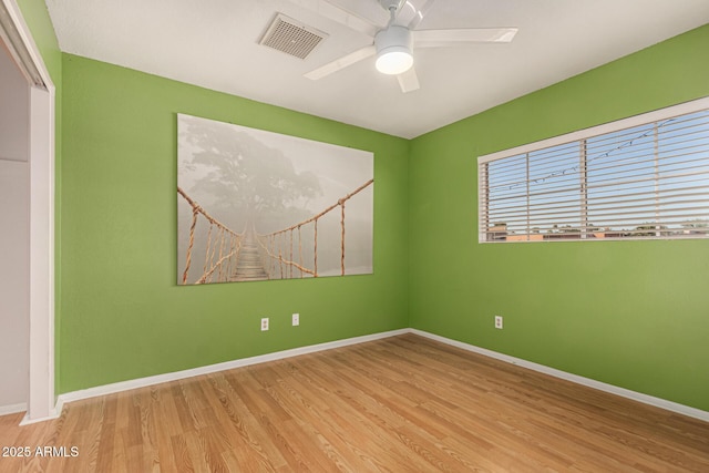 spare room featuring ceiling fan and light hardwood / wood-style flooring