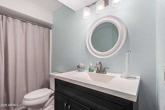 bathroom featuring vanity, toilet, and curtained shower