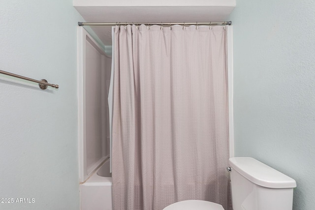 bathroom with shower / tub combo with curtain and toilet