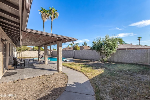 view of yard featuring a fenced in pool and a patio