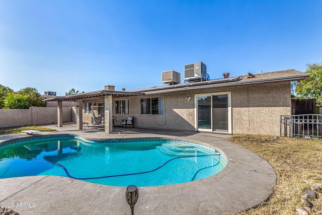 view of swimming pool featuring cooling unit, a patio, and a diving board