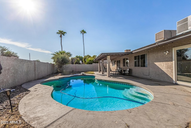 view of swimming pool with a diving board and a patio