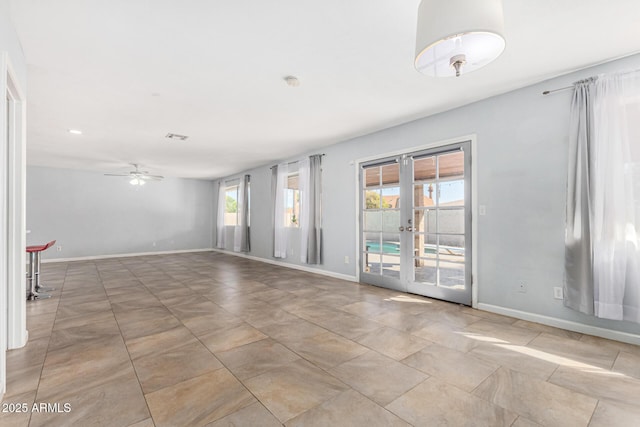 empty room with french doors and ceiling fan