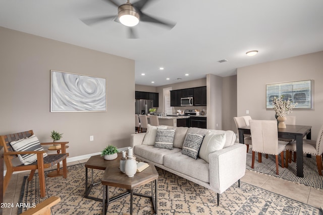 living room featuring ceiling fan and light tile patterned flooring