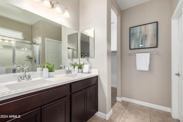 bathroom featuring tile patterned flooring, vanity, and an enclosed shower