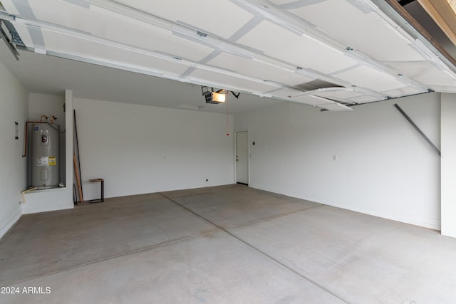 garage featuring electric water heater and a garage door opener