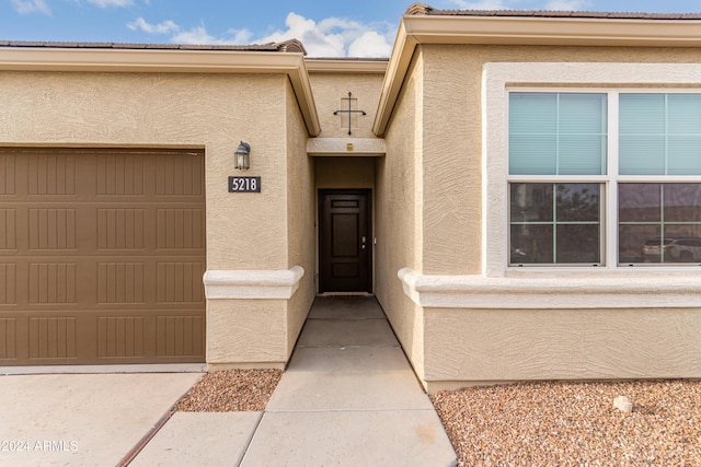 doorway to property with a garage