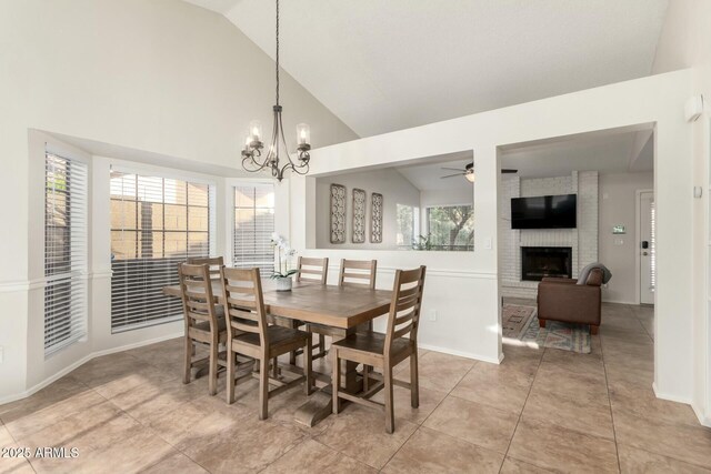 15621 S 37th Way, Phoenix, AZ 85048 - dining space with light tile patterned floors, baseboards, a brick fireplace, high vaulted ceiling, and ceiling fan with notable chandelier