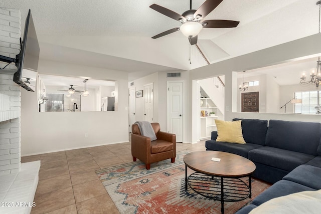 15621 S 37th Way, Phoenix, AZ 85048 - tiled living room with a textured ceiling, baseboards, visible vents, ceiling fan with notable chandelier, and lofted ceiling