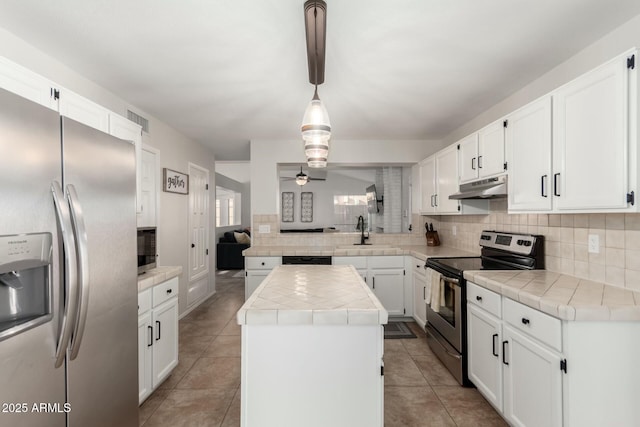 15621 S 37th Way, Phoenix, AZ 85048 - kitchen with tile counters, under cabinet range hood, stainless steel appliances, backsplash, and a sink