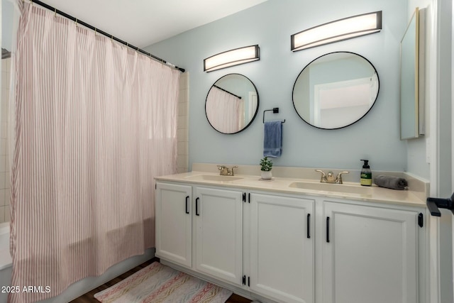 15621 S 37th Way, Phoenix, AZ 85048 - full bathroom featuring double vanity, shower / bath combo with shower curtain, and a sink